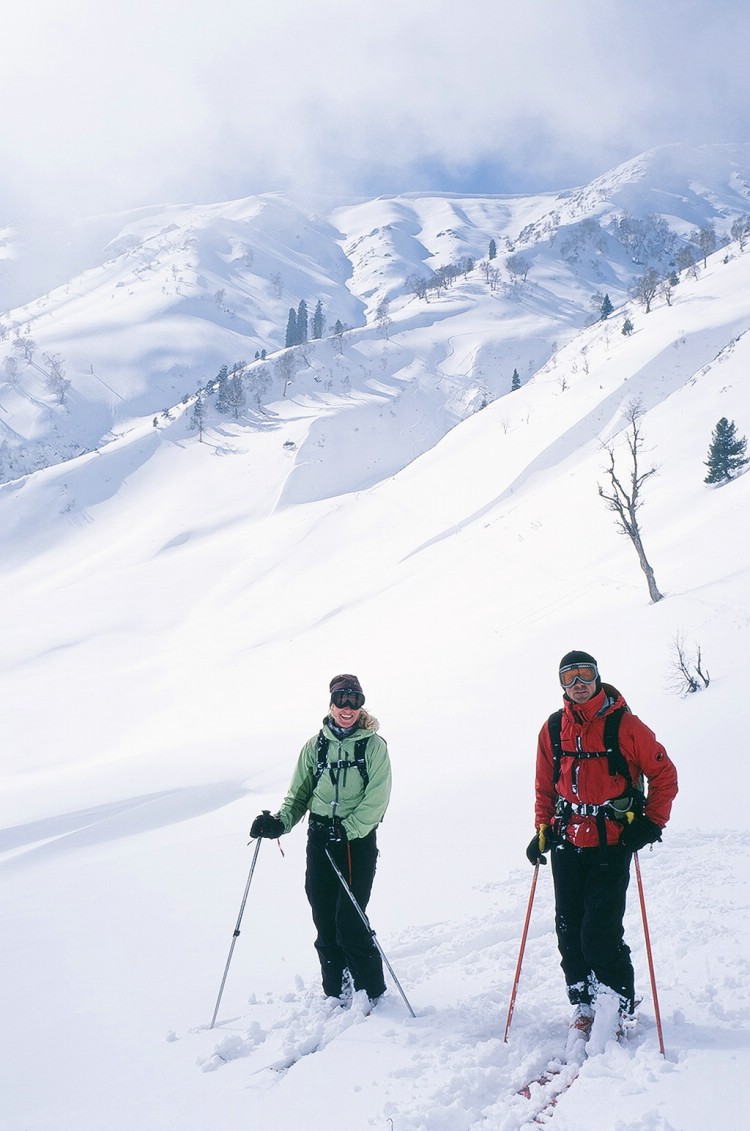 Swedish journalist Karin Sundström and Swedish mountainguide Jörgen Karström with that special glow after 1000m vertical of glory turns on the terrain skiers right of the gondola.    Photo: Ptor Spricenieks, skiherenow@yahoo.com 