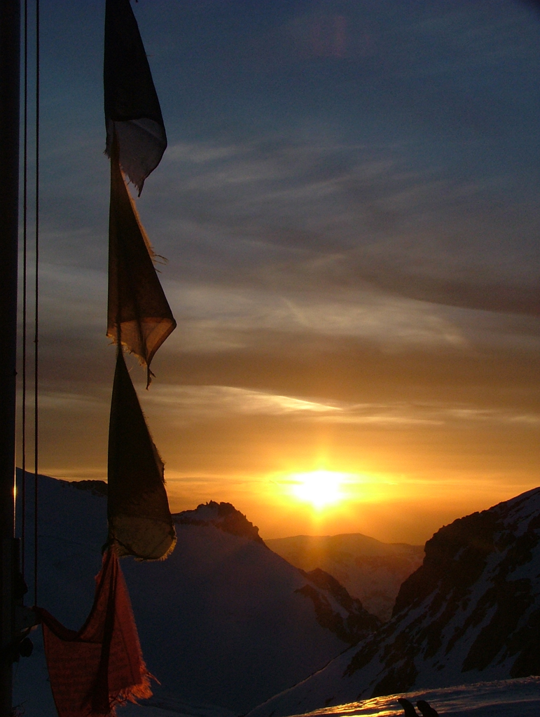 Tibetan prayer flags flutter in the breeze at dawn at the Trient Refuge.    Photo: Lisa Auer